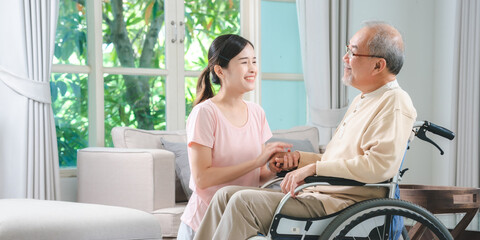 Asian family health care and insurance business at home concept, woman daughter take care support to senior elderly father patient in wheelchair together, dad having smile in happy love lifestyle
