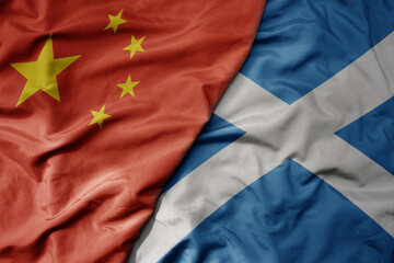 big waving national colorful flag of china and national flag of scotland .