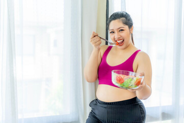Obraz na płótnie Canvas Overweight asian plump female ,fat women , Fat girl , Chubby, eating vegetable salad - lifestyle Woman diet weight loss overweight problem concept
