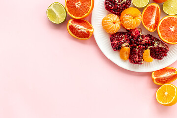 Fototapeta na wymiar Creative flatlay layout of juicy pomegranate and citrus