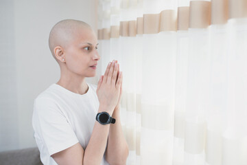 A woman with cancer after chemotherapy thanks the Lord for a successful recovery.