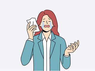 Upset woman crying wiping tears with paper napkin after business went bankrupt due to financial crisis. Sad businesswoman crying and needing support to solve psychological problems