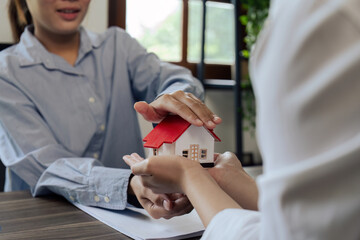 agent hand cover house model. real estate, insurance and property concepts after purchase