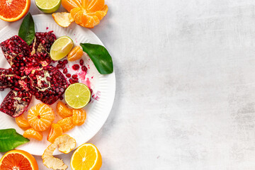 Creative flatlay layout of juicy pomegranate and citrus
