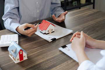 Real Estate Agent explain Property insurance and security concept about house to client before sign...