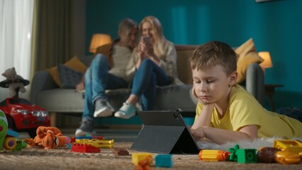 Adult young parents and their child spending leisure time at home together