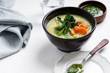 Minestrone soup with parsley pesto sauce, vegetable cream soup