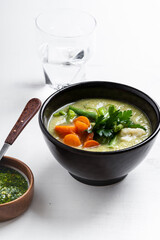 Minestrone soup with parsley pesto sauce, vegetable cream soup