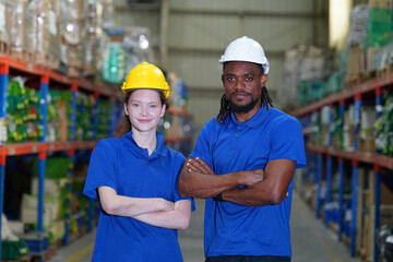 Worker working in large warehouse holding paper chart check list checking the material compare with the boxes wrapped with plastic keep on wooden pallet ready to ship to customer