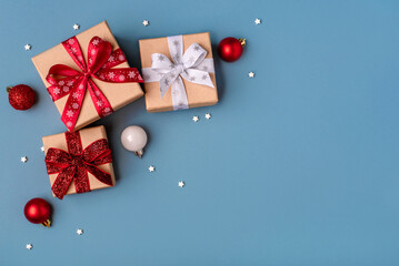 Gift boxes with Christmas decorations on blue background. Top view.