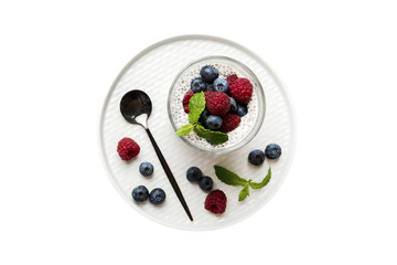 Healthy breakfast or morning with chia seeds vanilla pudding raspberry and blueberry berries on table background, vegetarian food, diet and health concept. Chia pudding with raspberry and blueberry