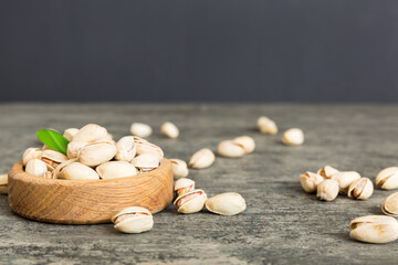 Fresh healthy Pistachios in bowl on colored table background. Top view Healthy eating concept. Super foods