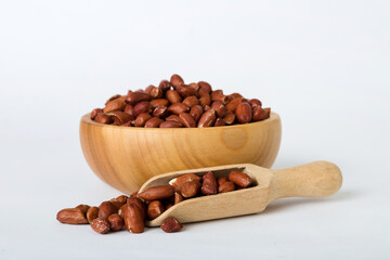 Fresh healthy peanuts in bowl on colored table background. Top view Healthy eating bertholletia concept. Super foods
