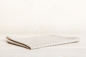 top view with gray kitchen napkin isolated on table background. Folded cloth for mockup with copy space, Flat lay. Minimal style