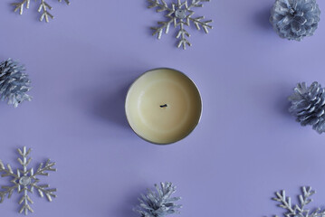 Soy candle in a metal jar on purple background. Winter and christmas season, top view - 627252834