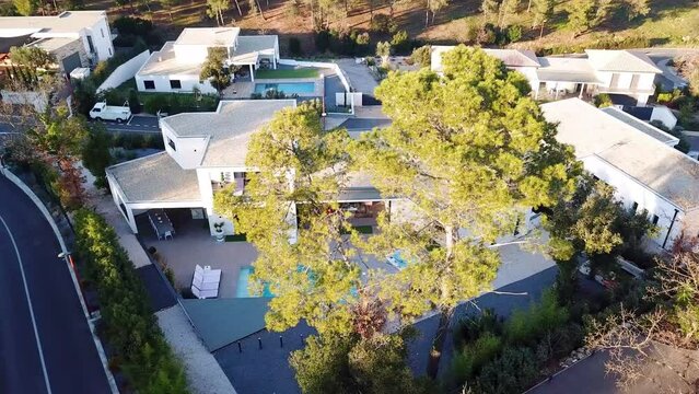 Aerial video sequence of luxurious and well stylish villa house with swimming pool at Sète city, south of France. Daytime capture.