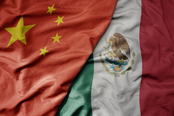 big waving national colorful flag of china and national flag of mexico .