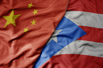 big waving national colorful flag of china and national flag of puerto rico .