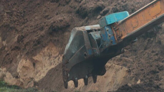 auto excavator with rotary bucket and telescopic boom digs a hole to replace the pipeline, industry