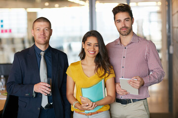 Teamwork is how well achieve success. Cropped portrait of three businesspeople standing in the office.