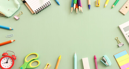 Back to school concept on pastel green background. Top view