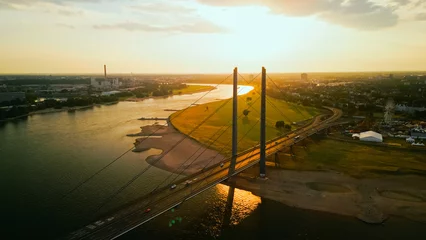 Papier Peint photo Tower Bridge Aerial drone view of Dusseldorf city, skyline with bridge and Rheinturm over river Rhine at sunset. 