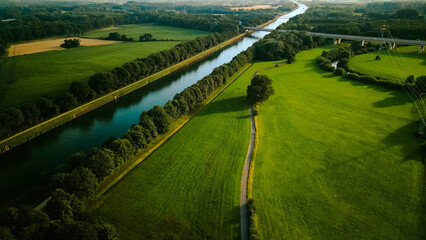 Summer aerial drone view landscape navigable river with bridges, agricultural fields and forests...