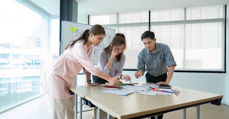 A group of startup Asian business people are stressed over the outcome of their meeting