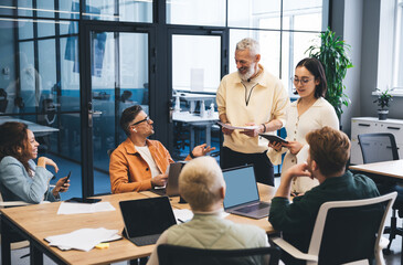 Group of diverse business partners brainstorming in conference room