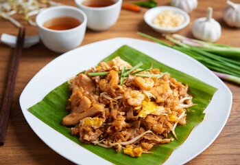 Penang Char Kway Teow or fried noodle with prawns, popular cuisine in Malaysia - obrazy, fototapety, plakaty