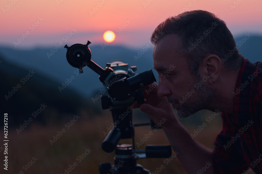 Canvas Prints astronomer looking at the sun with a telescope.