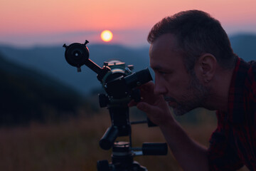 Astronomer looking at the sun with a telescope.