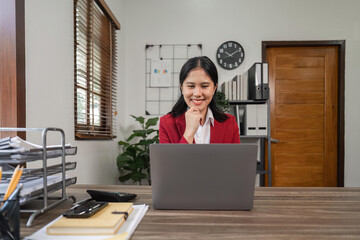 Young beautiful businesswoman working on laptop in bright modern office