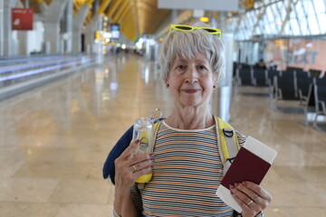 Senior woman presenting her documents at the airport 