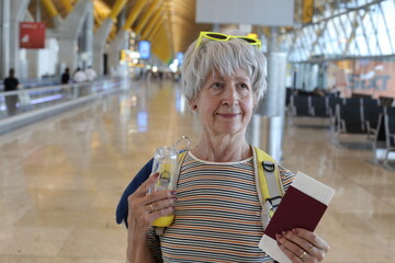 Senior woman presenting her documents at the airport