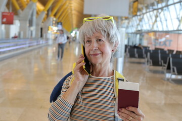Senior woman calling a call while boarding at the airport 