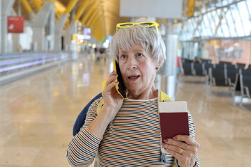 Senior traveler getting upsetting news on the phone 