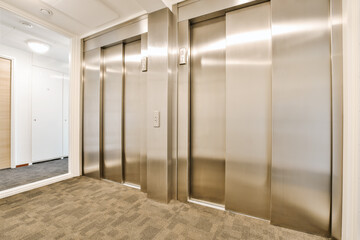 an elevator with two elevators in the middle and one on the second floor, as well as it is inside