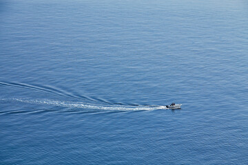 Boat cruising blue Mediterranean sea aerial view