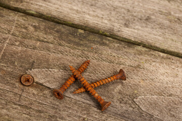 Top view of weathered pine wood decking planks with rusty screws