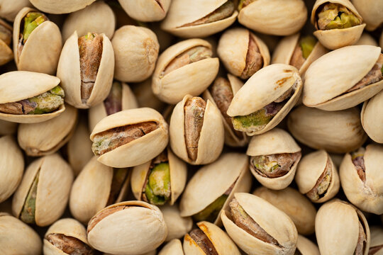 Salted Pistachios for Beer, Macro, Spin. Isolated Background of a Beer Snack of Salted Pistachio Nuts. Healthy Delicious Pistachios. Salted roasted pistachio macro	
