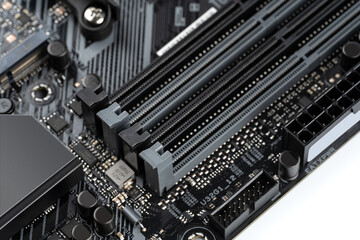 Closeup on empty RAM slots on a modern black silver motherboard. Ddr4, ddr5 memory stick slots. Macro electronics shot, technology, pc components. Shallow depth of field.