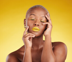 Creative, makeup and face with lipstick or black woman in studio on a yellow background for art, beauty or cosmetics. Gold, color and eyeshadow on calm model with eyes closed for fashion or aesthetic