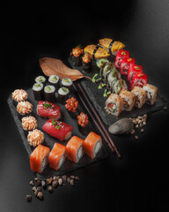 set of various maki and nigiri sushi on black background