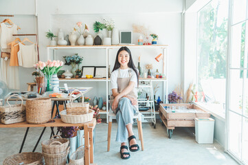 Small business owners pose smiling in their small shop to welcome customers and get customers online. And check the orders that customers have ordered of online retailers - online shopping.