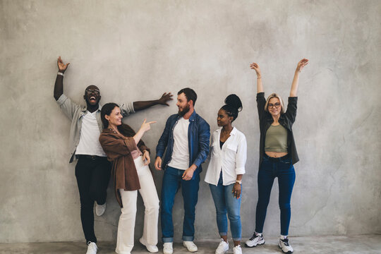 Group of diverse friends having fun while standing in office