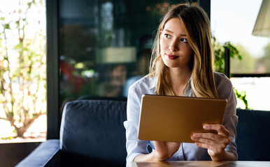 Beautiful success woman working, using digital tablet. Business, freelancer, social media concept.
