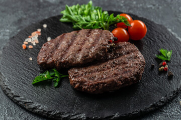 grilled hamburger patties on a dark background, banner, menu, recipe place for text, top view