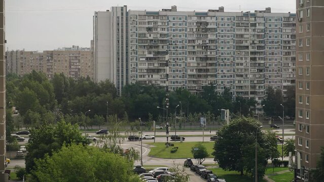 High-rise Apartment Buildings And A Busy Highway Next To Them. Transport Is Moving Along The Highway