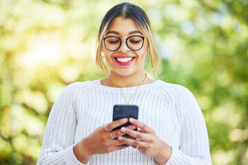 Woman, phone and texting in park with smile, online date and communication on web chat in summer. Student girl, smartphone and happy for chat, social network app and contact with thinking in nature